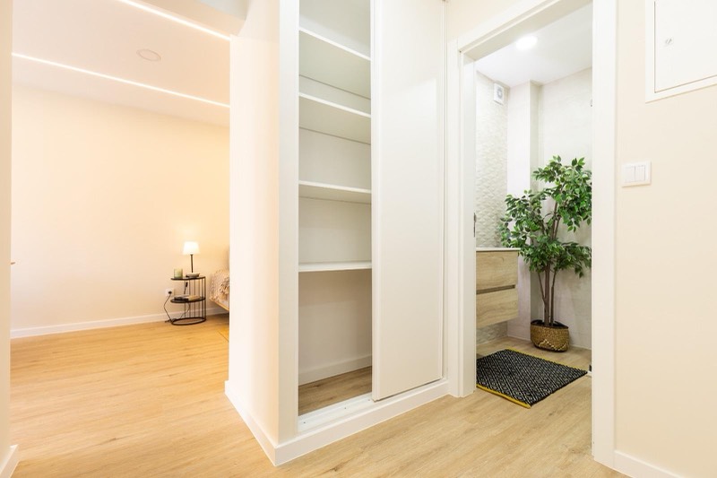 Hallway with fitted wardrobe and bathroom door